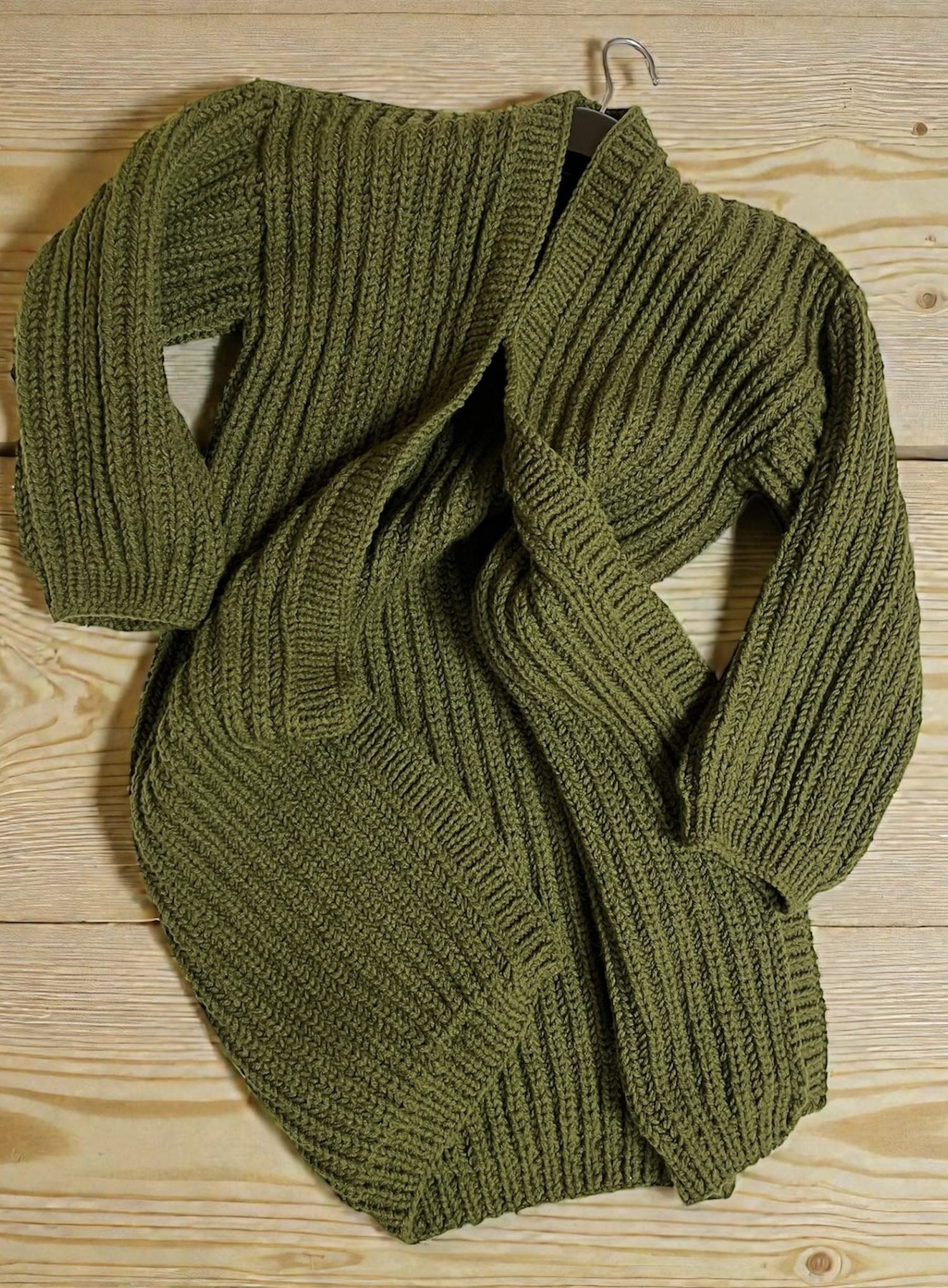 An olive green ribbed cardigan laid flat