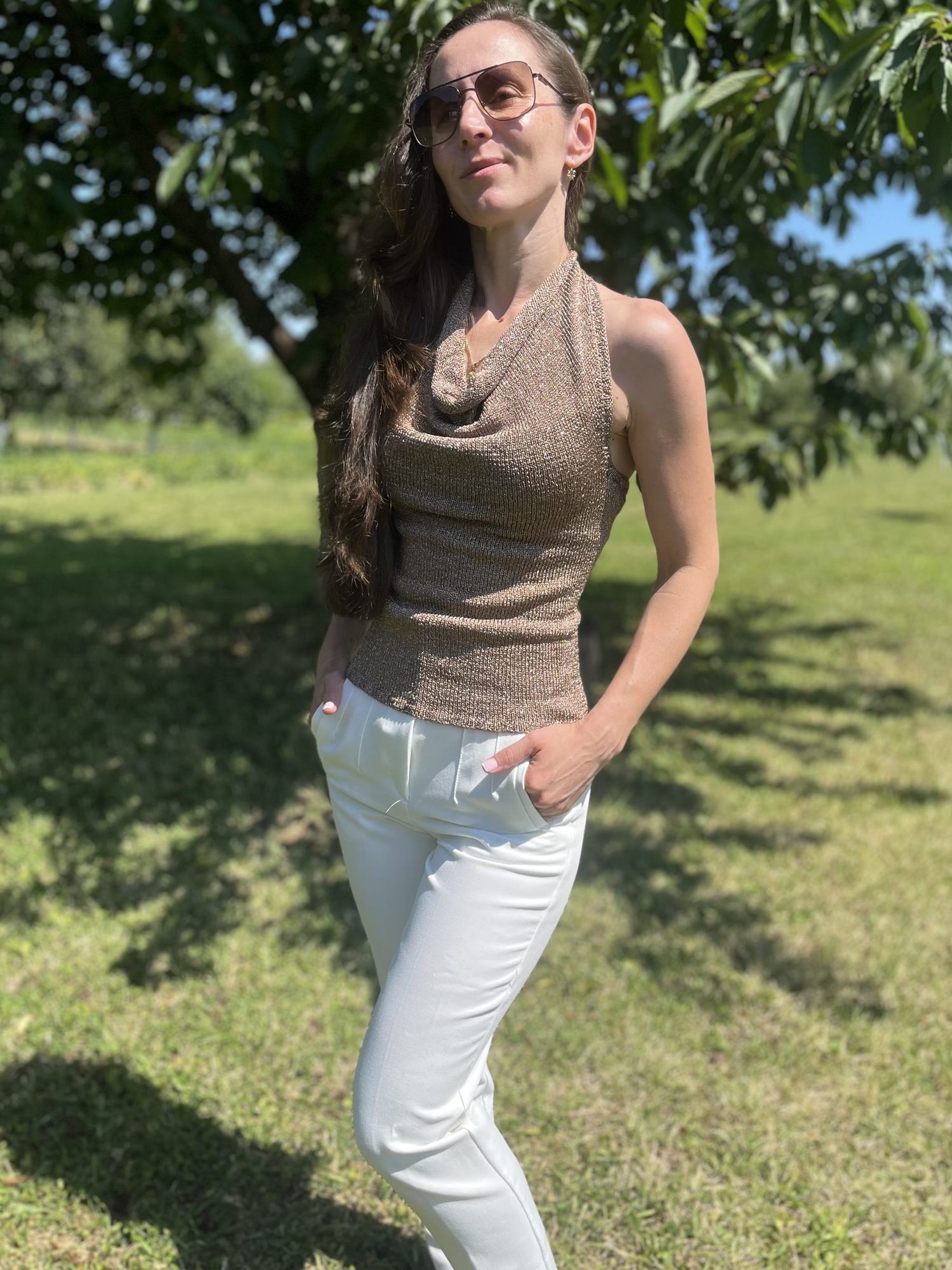 Bronze metallic halter knit top worn outdoors in the sun