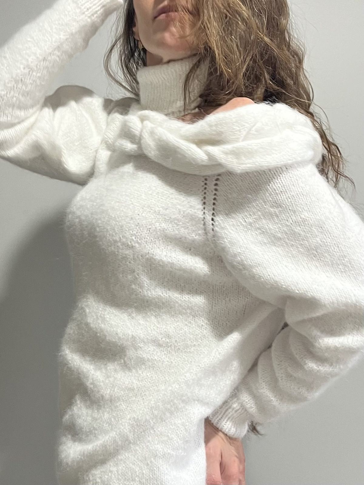 Close-up of a hand-knit white sweater